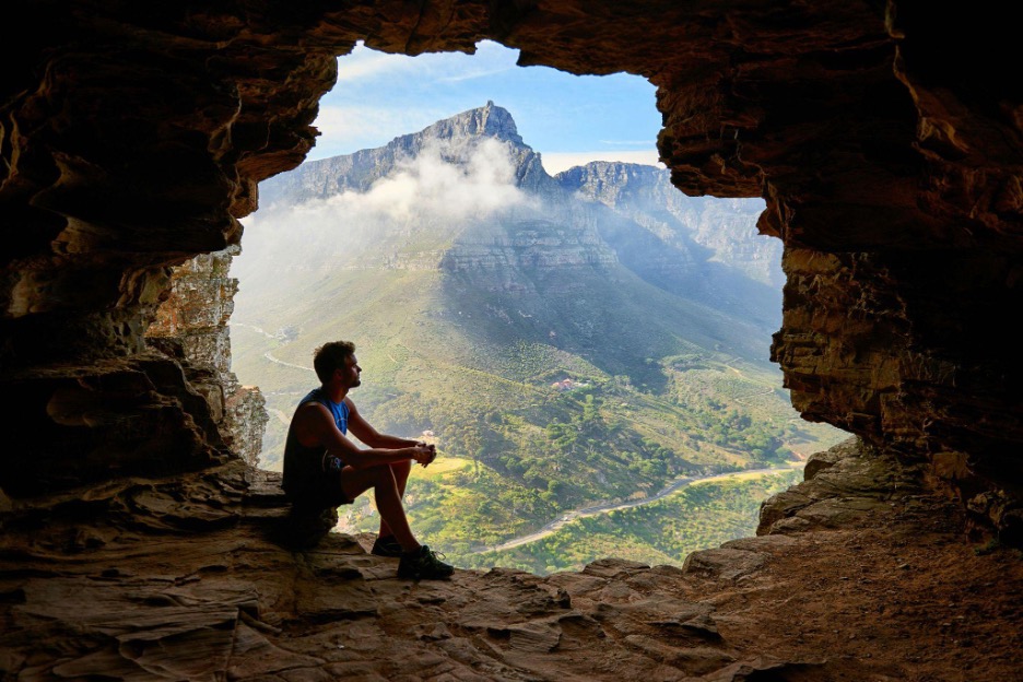 man sitting on cliff